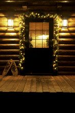 Christmas Decorations Around A Log Cabin Door