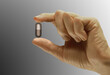 © SuperStock - Close-up of a person's hand holding a capsule
