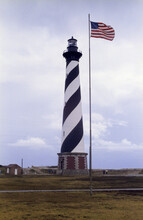 American Flag Near The Cape Hatteras Lighthouse, Cape Hatteras National Seashore, North Carolina, USA, Prior To 1999 Relocation