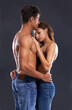 © Marius V/peopleimages.com - Hold me close through the night. Studio shot of a passionate couple embracing against a gary background.