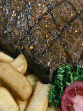 Close-up Of Grilled Meat With French Fries