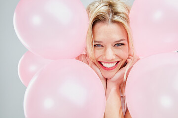 Wall Mural - Im not sure why but Im so happy. Cropped shot of a beautiful young woman posing with pink balloons.