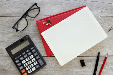Wall Mural - Top view of an open notebook on a red notebook, with a spiral spring, flat office notepad