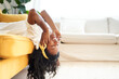 © CarlosBarquero - Young woman relaxing at home listening to music on headphones lying on the sofa enjoying the freedom of free time.