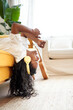 © CarlosBarquero - Vertical photo of a Young woman relaxing at home listening to music on headphones lying on the sofa enjoying the freedom of free time.