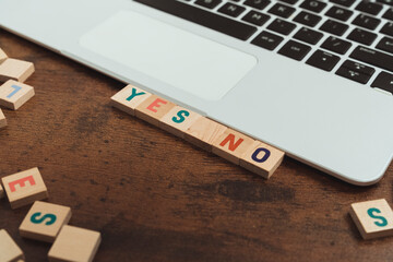 Words YES and NO made of wooden alphabet letters vocabulary game selective focus doubt concept . High quality photo