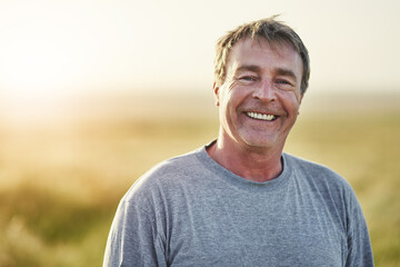 ive always loved the fresh air. portrait of a mature man standing outdoors.