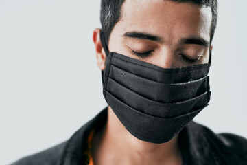 Poster - Your face mask matters. Studio shot of a masked young man posing against a grey background.