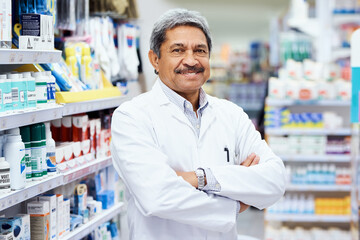 Sticker - Here to help you get better. Portrait of a mature pharmacist working in a chemist.