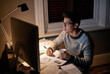© Marius V/peopleimages.com - Determined to get it done. Cropped shot of a young student studying late into the night.