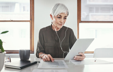 Poster - Next to her, technology is the companys greatest asset. Cropped shot of an attractive mature businesswoman working on her tablet in the office.