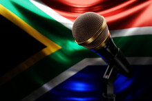 Microphone On The Background Of The National Flag Of South African Republic, Realistic 3d Illustration. Music Award, Karaoke, Radio And Recording Studio Sound Equipment
