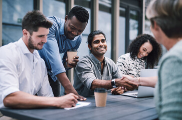 Poster - Good business is built on good relationships. Shot of a businessman and businesswomen shaking hands during a meeting with colleagues.