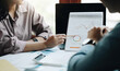 © Natee Meepian - Business people are meeting for analysis data figures to plan business strategies. Business discussing concept.