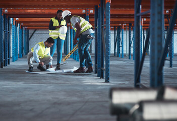 Aufkleber - We speak engineer fluently. Shot of a group of contractors using a blueprint to plan in the warehouse.