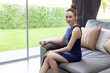 © Yanukit - smart looking asian blue dress and high shoes on sofa