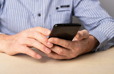 Poster - Man hands closeup with phone. Using smartphone for work, social communication, education,online shopping, information search, relax. High quality photo