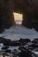 A Sunset Sky Peeping Thought The Keyhole Arch At Pfeiffer Beach, Near Big Sur California.