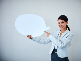 Aufkleber - Let her speak your idea. Studio shot of an attractive corporate businesswoman holding up a speech bubble against a gray background.