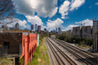 a long stretch of railroad tracks surrounded by office buildings and apartments, bare winter trees and lush green trees with colorful buildings and blue sky with clouds in midtown Atlanta Georgia USA