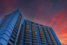 A Tall Blue Glass Skyscraper With Balconies With Blue Sky And Powerful Red Clouds At Sunset In Atlanta Georgia USA