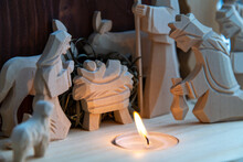 Christmas Nativity Scene With Wooden Figures. Mary, Joseph, Shepherd And Magi (three Wise Men) Are Standing Near The Manger Of Jesus Christ In The Cave. Candle As A Hearth. Christmas Decoration Theme.