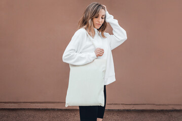 Wall Mural - Woman with cotton bag on her shoulder, mockup.