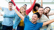 Group of multiracial people with hands up smiling at camera together - Corporate team colleagues congratulating coworker with business success in coworking shared office