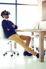 Poster - The future never looked better. Shot of a businessman wearing a VR headset while leaning back in his office chair at work.