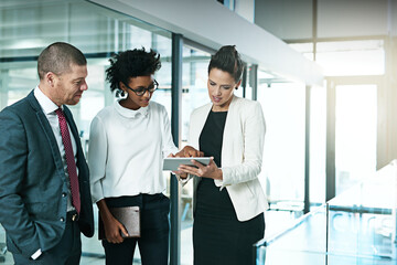 Aufkleber - I think we should go with this idea. Shot of a business team using a digital tablet while having an informal meeting.