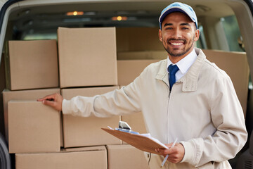 Poster - Service with a smile. Portrait of a friendly delivery man standing next to a van full of boxes.