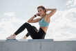 © muse studio - Athletic woman active outdoor workout, stretching and body warm-up, sportswear