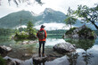© Claudiu - Rear View Of Man with backpack, hat and orange sofshell jacket Looking At Lake Against Mountains, Hintersee Lake, Bavaria