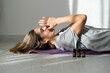 woman meditates with essential oils while lying on a yoga mat. Ultrasonic and humidifying aromatherapy. Meditation fitness and exercise concept copy space. Active lifestyle. home or gym club