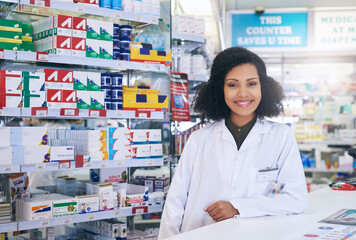 Poster - Ill do my best to answer any question you may have. Cropped portrait of an attractive young female pharmacist working in a pharmacy.