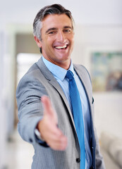 Poster - The start a successful partnership. Portrait of a smiling mature businessman extending his arm to shake hands.