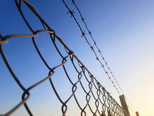 Barbed Wire And Fence Surrounding Private Property Or Military Zone