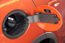 Open Fuel Filler Cap Of An Orange Vehicle