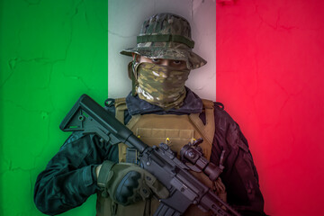 Angry italian soldier armed with a rifle with italy flag as background behind