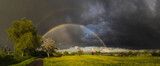 Fototapeta Tęcza - storm and double rainbow over a field