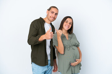 Wall Mural - Young caucasian couple isolated on white background pregnant and with thumb up