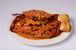 SINGAPOREAN CHILI CRAB with sauce in a dish top view on grey background singapore food