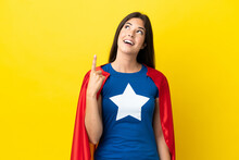 Super Hero Brazilian Woman Isolated On Yellow Background Pointing Up And Surprised