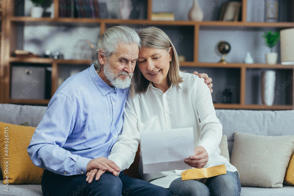 Retiree Smiling Senior gray haired family member receiving letter or document rejoicing ...