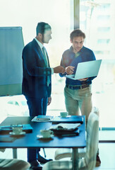 Aufkleber - Project planning in the boardroom. Shot of a two businessman working together on a laptop while standing in an office.