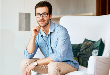 Wall Mural - Enjoying some personal time. Portrait of a handsome young man relaxing at home.