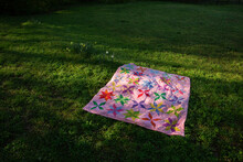 Colorful Quilt On Lawn