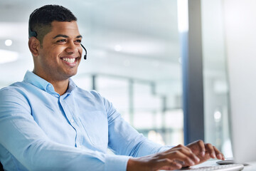 Wall Mural - being friendly goes a long way. shot of a handsome young call centre agent sitting in the office and