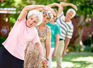 Canvas Print - Staying active is key to a healthy retirement. Shot of a group of smiling seniors exercising outside.