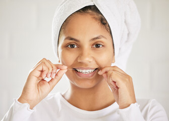 Poster - Life is short. Smile while you still have teeth. Shot of an attractive young woman flossing her teeth in the bathroom.
